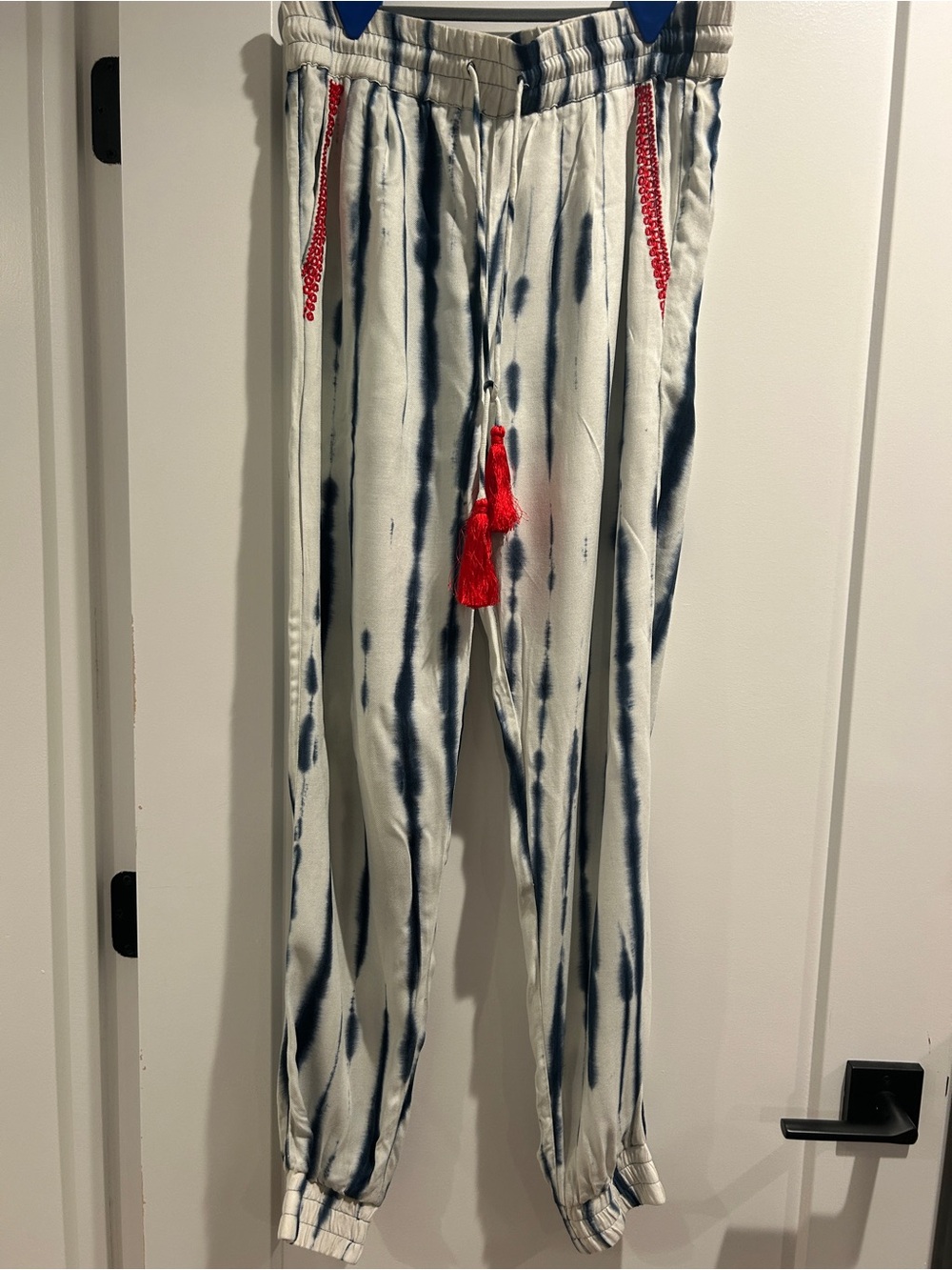 HEMANT & NANDITA White Tie-Dye Jogger Pants with Red Tassel Accents
